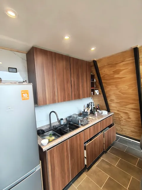 The kitchen: fridge, hob, sink and everything you need to cook for yourselves
