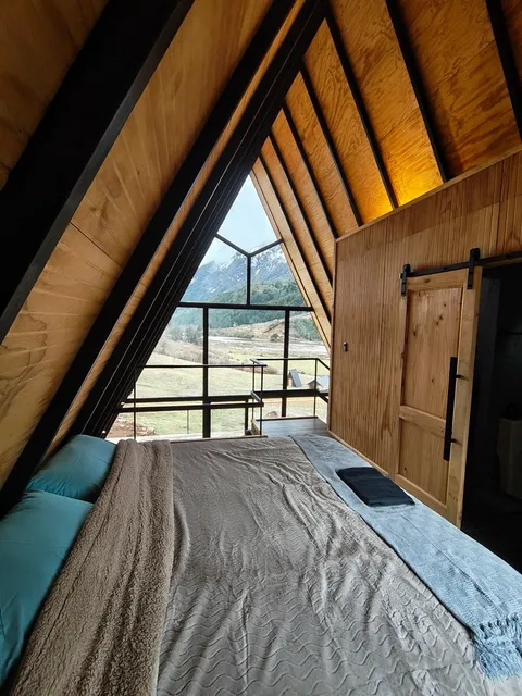 The loft bedroom upstairs, looking out at the mountains and the valley